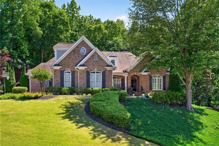Front exterior of 800 E Shore Drive, a brick home with a manicured lawn
