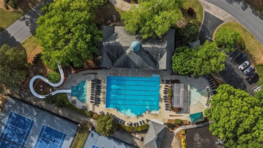 Overhead drone view of the Cambridge lap pool, the curving water slide and the clubhouse roof